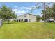 A well-maintained backyard and side exterior view of this two-story townhome boasts a serene and private outdoor space at 9492 Flowering Cottonwood Rd # 82, Orlando, FL 32832