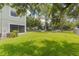 Lush, expansive lawn surrounding the townhome provides a serene and private outdoor space with mature trees at 9492 Flowering Cottonwood Rd # 82, Orlando, FL 32832