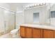 Bright bathroom featuring a glass shower, vanity, and a large mirror at 9492 Flowering Cottonwood Rd # 82, Orlando, FL 32832