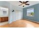 Bedroom with hardwood floors, ceiling fan, a window, closet, and an attached bathroom at 9492 Flowering Cottonwood Rd # 82, Orlando, FL 32832