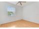 Bright bedroom with wood flooring, a ceiling fan, and a large window with blinds at 9492 Flowering Cottonwood Rd # 82, Orlando, FL 32832