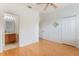 Bright bedroom with hardwood floors, ceiling fan, and attached bathroom at 9492 Flowering Cottonwood Rd # 82, Orlando, FL 32832