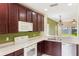 Functional kitchen with white appliances, dark cabinetry, and ample counter space for easy meal preparation at 9492 Flowering Cottonwood Rd # 82, Orlando, FL 32832