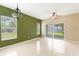 Bright living room with large windows, tile floors, and sliding glass doors to outdoor space at 9492 Flowering Cottonwood Rd # 82, Orlando, FL 32832