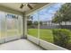 Relaxing screened patio overlooking a green backyard, perfect for outdoor enjoyment with a ceiling fan at 9492 Flowering Cottonwood Rd # 82, Orlando, FL 32832