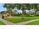 Well-maintained community playground set amidst lush greenery provides a safe and engaging space for children to play at 9492 Flowering Cottonwood Rd # 82, Orlando, FL 32832
