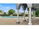Community pool with ample lounge space, framed by elegant columns, offers residents a luxurious outdoor experience at 9492 Flowering Cottonwood Rd # 82, Orlando, FL 32832