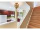 View of staircase and open kitchen layout featuring light fixtures, modern appliances, and tile flooring at 9492 Flowering Cottonwood Rd # 82, Orlando, FL 32832