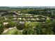 Scenic aerial view of a homesite surrounded by lush greenery and mature trees near a golf course at 9517 San Fernando Ct, Howey In The Hills, FL 34737