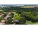 Aerial view of a homesite surrounded by lush greenery and mature trees in a golf community at 9517 San Fernando Ct, Howey In The Hills, FL 34737