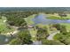 Spectacular aerial view of a golf course community with lakes and bridges weaving through the lush landscape at 9517 San Fernando Ct, Howey In The Hills, FL 34737