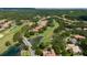 Scenic aerial view of homes nestled within a lush golf course community, complete with ponds at 9517 San Fernando Ct, Howey In The Hills, FL 34737