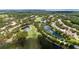 Beautiful aerial showcasing a golf community with serene ponds amidst a lush green golf course at 9517 San Fernando Ct, Howey In The Hills, FL 34737