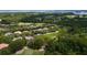 Aerial view of a homesite surrounded by lush greenery and mature trees in a golf community at 9517 San Fernando Ct, Howey In The Hills, FL 34737