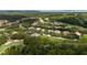 Beautiful aerial view of a homesite surrounded by lush greenery and mature trees in a golf community at 9517 San Fernando Ct, Howey In The Hills, FL 34737