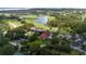 Aerial view of a golf course clubhouse featuring manicured grounds and surrounded by trees at 9517 San Fernando Ct, Howey In The Hills, FL 34737