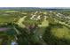 Overhead view of a golf course community highlighting lush fairways, a lake, and well-kept greenery at 9517 San Fernando Ct, Howey In The Hills, FL 34737