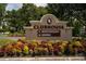 Attractive clubhouse sign surrounded by colorful flowers, directing visitors to Nickers Restaurant and Legends at 9517 San Fernando Ct, Howey In The Hills, FL 34737