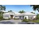Charming single story home featuring a symmetrical façade, a light colored roof, and lush landscaping at 9517 San Fernando Ct, Howey In The Hills, FL 34737