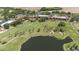 Beautiful aerial view of the golf course, featuring water features and lush landscaping in a resort community at 9517 San Fernando Ct, Howey In The Hills, FL 34737