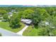 An aerial view of the home showcasing its well-manicured lawn, mature trees, and charming neighborhood at 102 Mayrose Dr, Sanford, FL 32771