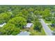 Birds-eye view of the home and neighborhood with mature trees and well-kept lawns at 102 Mayrose Dr, Sanford, FL 32771