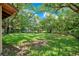 Large, fully fenced backyard with vibrant green grass, mature shade trees, and ample space at 102 Mayrose Dr, Sanford, FL 32771