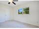 Bright bedroom featuring a ceiling fan, neutral walls, and a large window for ample natural light at 102 Mayrose Dr, Sanford, FL 32771
