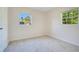 Cozy bedroom with neutral walls, carpet floors, and natural light from two windows at 102 Mayrose Dr, Sanford, FL 32771