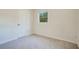 Neutral bedroom with a window and door with carpeted floors at 102 Mayrose Dr, Sanford, FL 32771