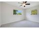Spacious bedroom with a ceiling fan and lots of natural light from two windows at 102 Mayrose Dr, Sanford, FL 32771