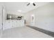 Open kitchen area with gray cabinets, stainless steel appliances, and tile floors at 102 Mayrose Dr, Sanford, FL 32771