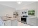 A modern kitchen featuring updated cabinets, stainless steel appliances, and granite countertops at 102 Mayrose Dr, Sanford, FL 32771