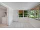 Finished laundry room with washer, dryer, tile flooring and abundant natural light from many windows at 102 Mayrose Dr, Sanford, FL 32771