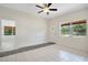 Open-concept living room features tile flooring, fan, fresh paint and ample natural light at 102 Mayrose Dr, Sanford, FL 32771