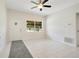 Bright living room with ceiling fan, white tile floors, neutral paint, and natural light at 102 Mayrose Dr, Sanford, FL 32771