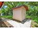 Exterior view of the storage shed with durable siding and well-maintained landscaping at 102 Mayrose Dr, Sanford, FL 32771