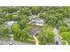 Beautiful aerial view of a lovely home with a spacious, fenced backyard surrounded by lush greenery and mature trees at 1210 S Palmetto Ave, Sanford, FL 32771