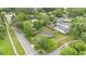 An aerial view of a quaint home with a large, fenced backyard on a tree-lined street in a friendly neighborhood at 1210 S Palmetto Ave, Sanford, FL 32771