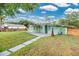 Charming home featuring a spacious backyard, patio, and a walkway to the green, manicured lawn at 1210 S Palmetto Ave, Sanford, FL 32771