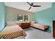 Eclectic bedroom with twin beds, bright geometric wallpaper, and terrazzo flooring at 1210 S Palmetto Ave, Sanford, FL 32771