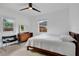 Bedroom showcasing neutral colors, terrazzo flooring, large windows, and mid-century modern furniture at 1210 S Palmetto Ave, Sanford, FL 32771