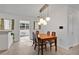 Bright dining room with a view to the kitchen featuring a modern chandelier at 1210 S Palmetto Ave, Sanford, FL 32771