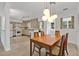 Bright dining room with a view to the kitchen featuring a modern light fixture at 1210 S Palmetto Ave, Sanford, FL 32771