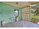 Inviting front porch featuring decorative concrete blockwork, seating, and modern fixtures at 1210 S Palmetto Ave, Sanford, FL 32771