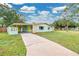 Charming vintage home featuring a long driveway, a carport, and quaint curb appeal at 1210 S Palmetto Ave, Sanford, FL 32771