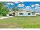 Charming vintage home featuring a well-manicured lawn, carport, and quaint curb appeal at 1210 S Palmetto Ave, Sanford, FL 32771