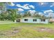 Single story ranch-style home with a long driveway and green grass and a carport on the side at 1210 S Palmetto Ave, Sanford, FL 32771