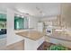 Bright kitchen with bar seating featuring white appliances, ample counter space, and natural light at 1210 S Palmetto Ave, Sanford, FL 32771