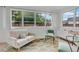 Cozy sitting room with large windows, neutral-toned furniture, and a colorful area rug at 1210 S Palmetto Ave, Sanford, FL 32771